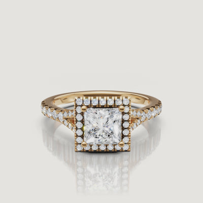 A high-definition 360-degree video of a Raul Diamonds princess cut diamond ring in yellow gold, highlighting the sharp corners of the halo and the sparkling split shank.