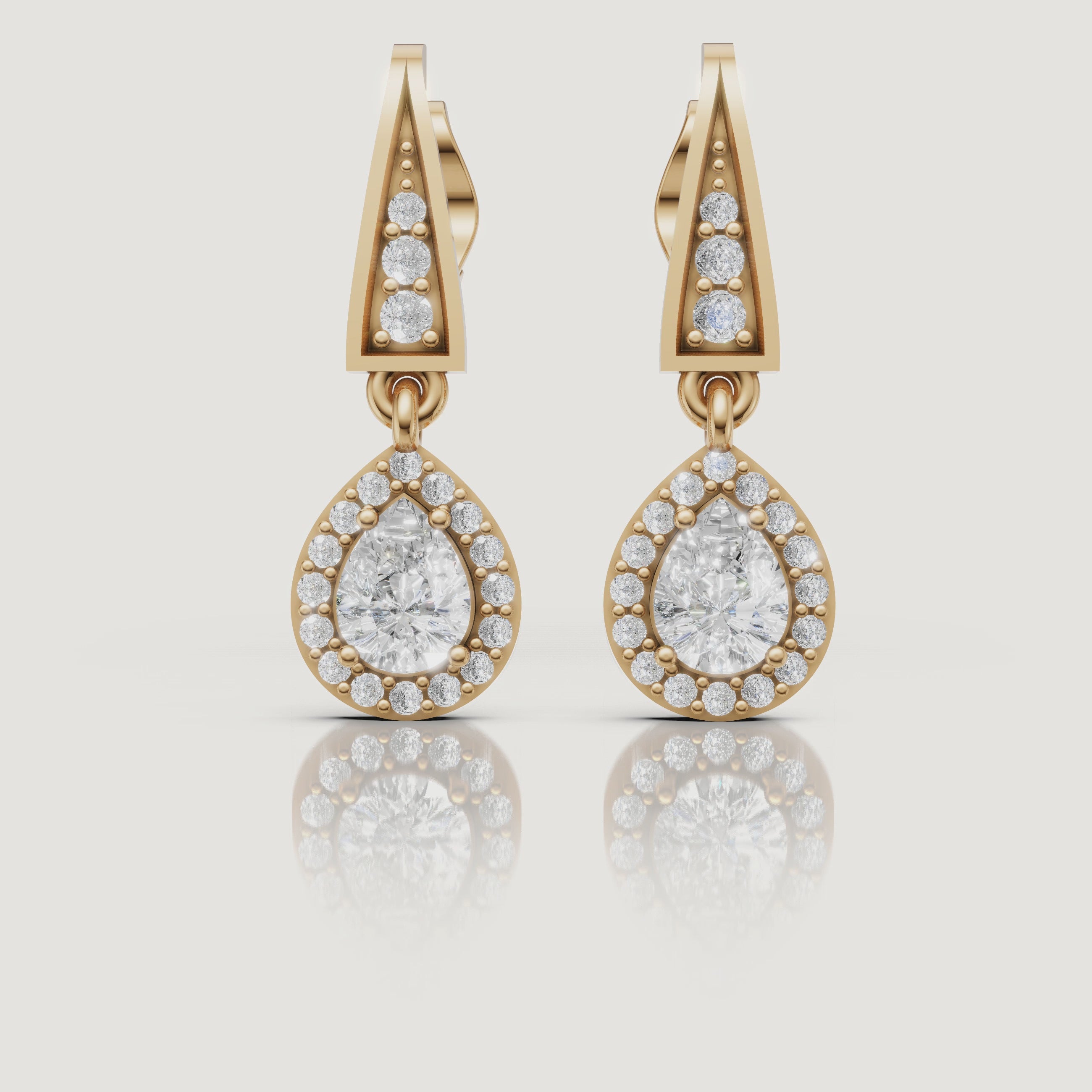 Yellow gold pear halo diamond drop earrings video showcasing elegant brilliance by Raul Diamonds