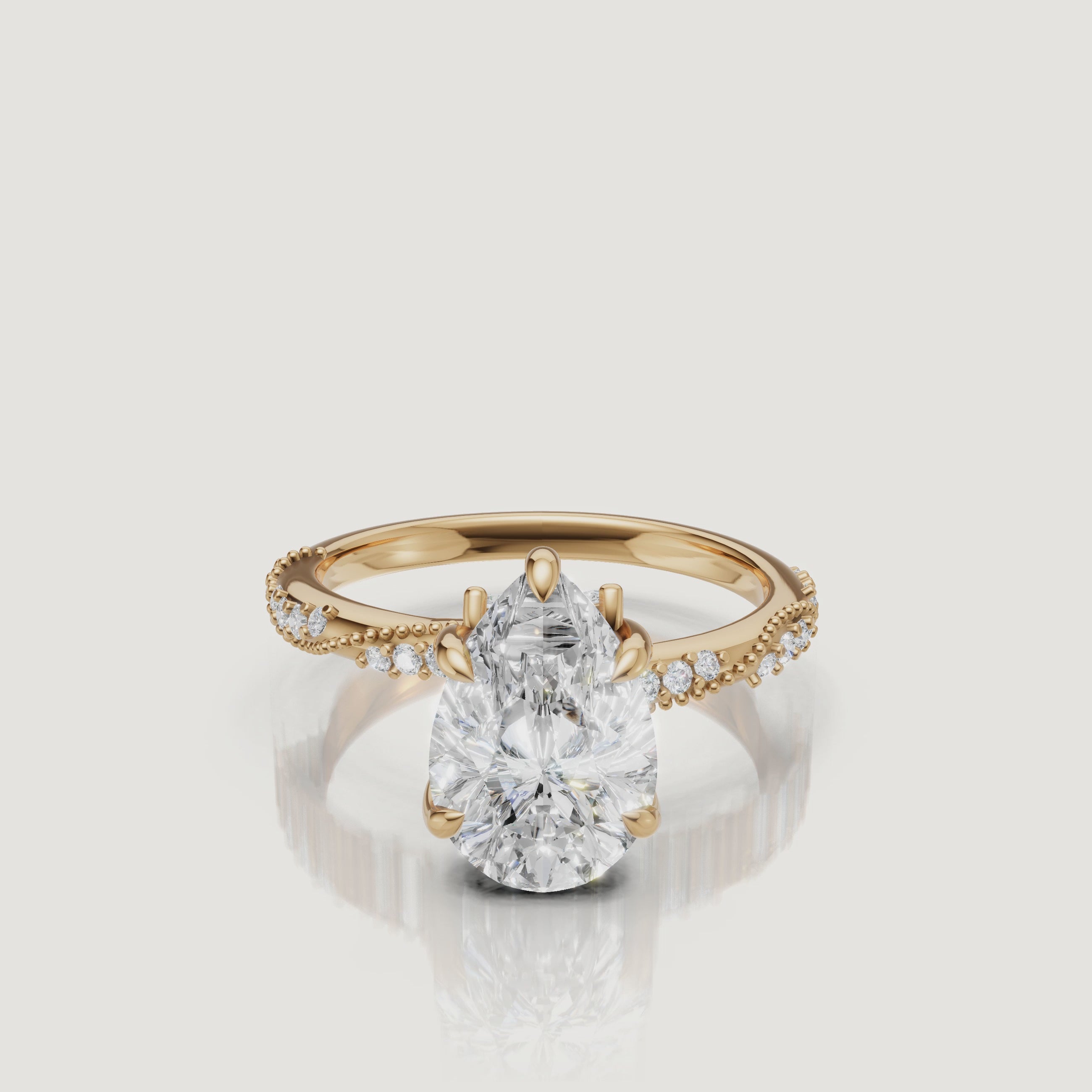 14K yellow gold pear cut lab grown diamond engagement ring with twisted pavé band and elegant teardrop sparkle by Raul Diamonds