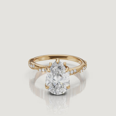 14K yellow gold pear cut lab grown diamond engagement ring with twisted pavé band and elegant teardrop sparkle by Raul Diamonds