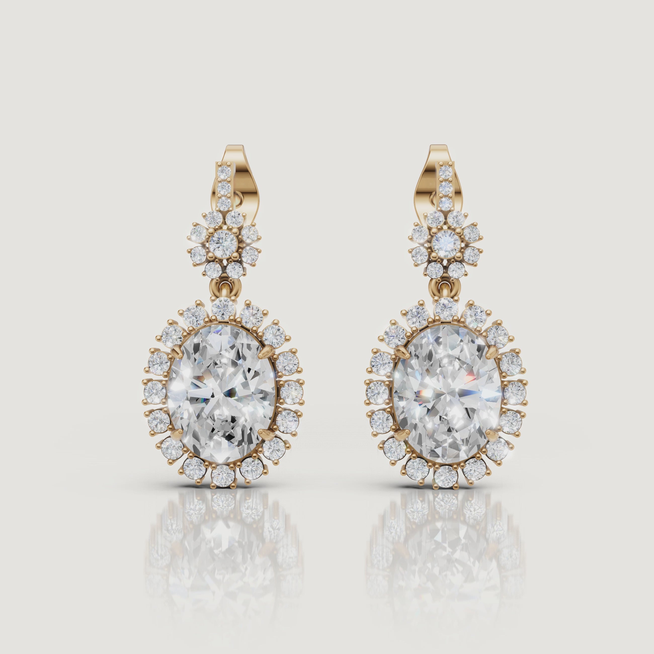 Yellow gold oval halo diamond drop earrings video showcasing vintage luxury brilliance by Raul Diamonds