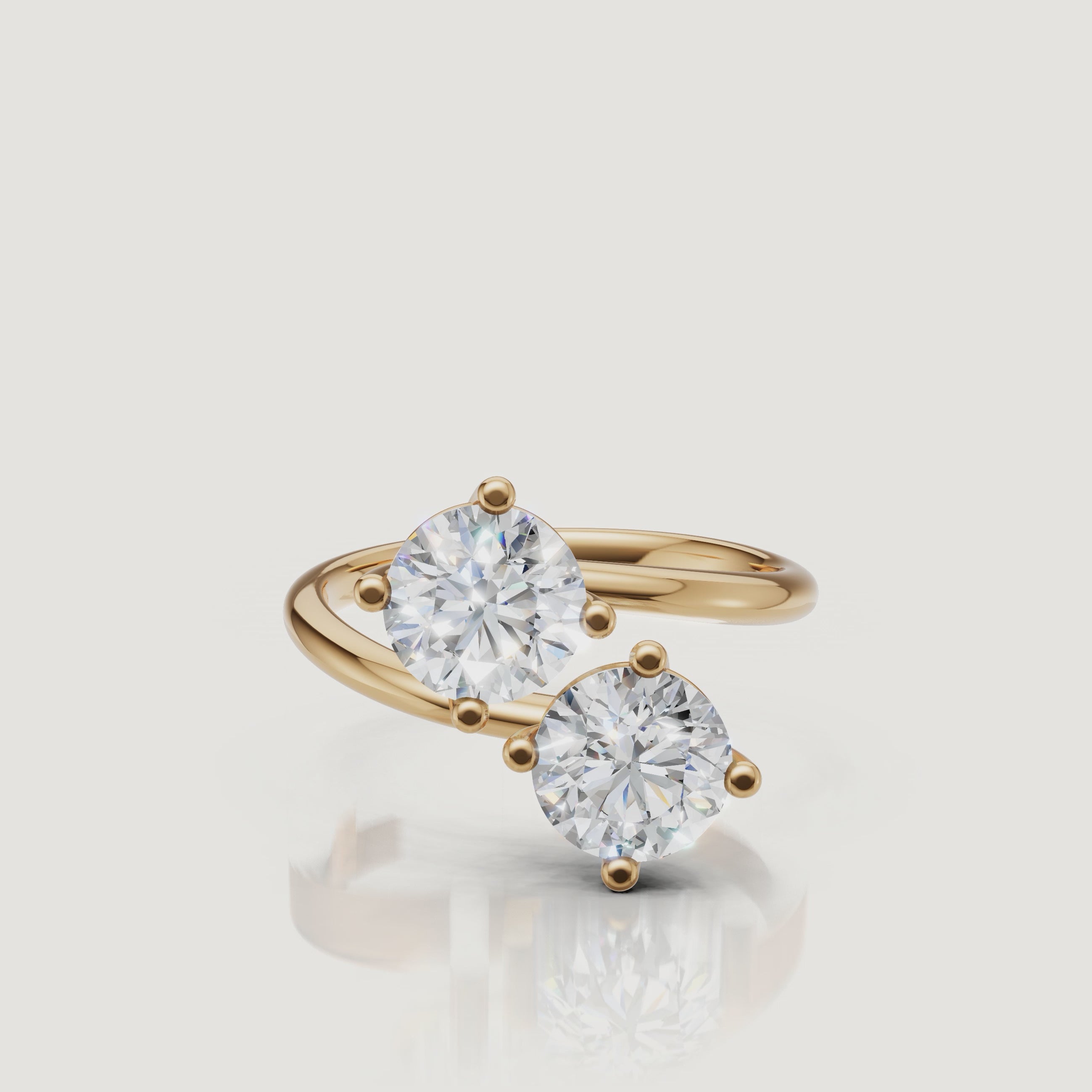 Yellow Gold Video Alt: Rotating video of Raul Diamonds yellow gold bypass ring with dual round diamonds