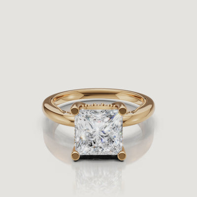 Cinematic 4K video of a Raul Diamonds princess cut ring in yellow gold, rotating to showcase the inverted pyramid profile and warm 18k gold glow.