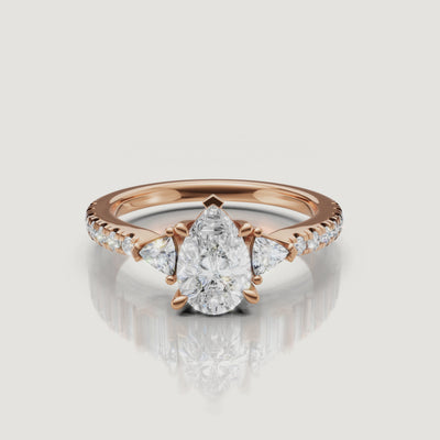 Cinematic video showcase of a Rual Diamonds three-stone pear diamond ring, capturing the exceptional fire, brilliance, and shimmering pavé shank
