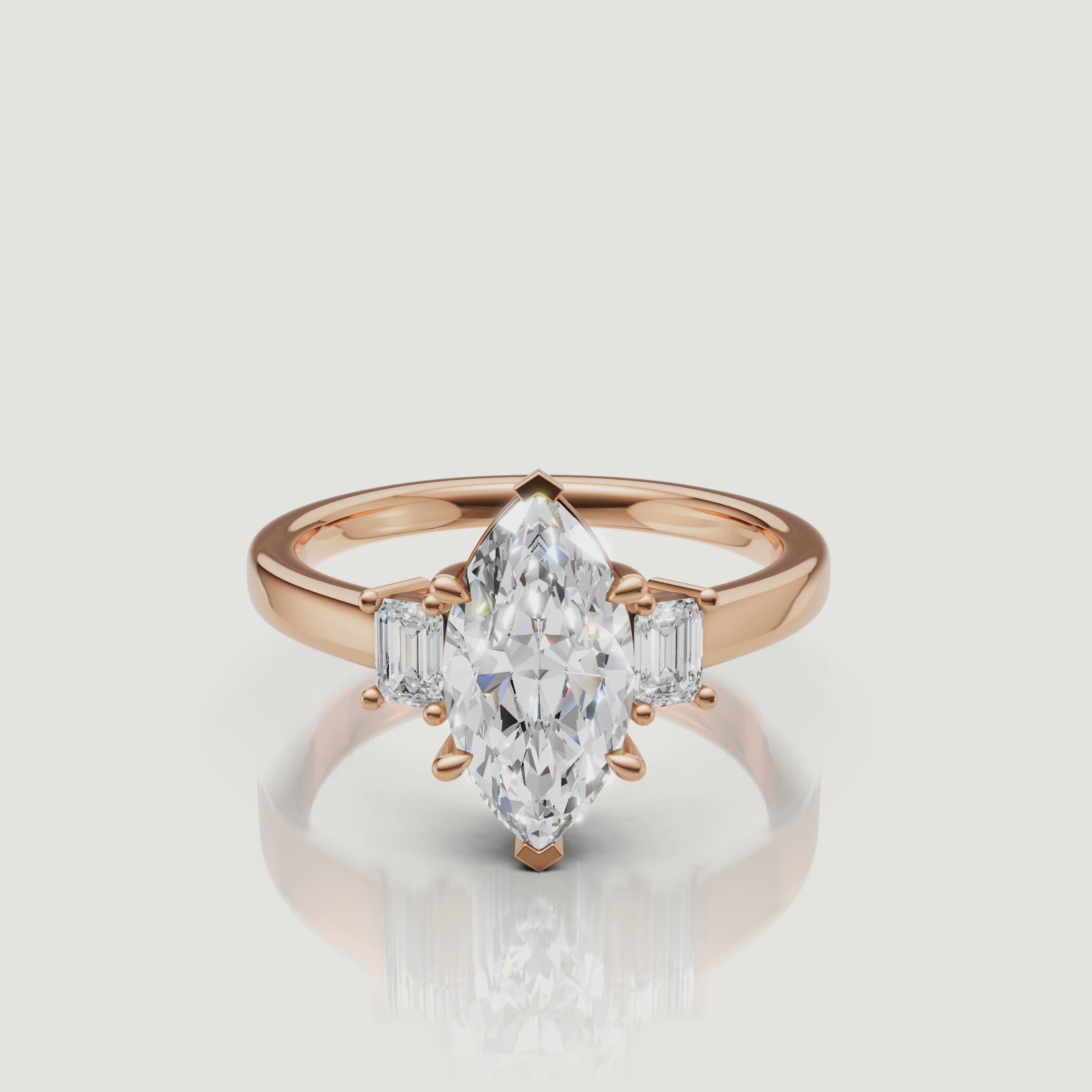 Cinematic close-up of a Rual Diamonds rose gold marquise-cut diamond ring, capturing the warm romantic tones and exceptional brilliance of the three-stone design in motion.