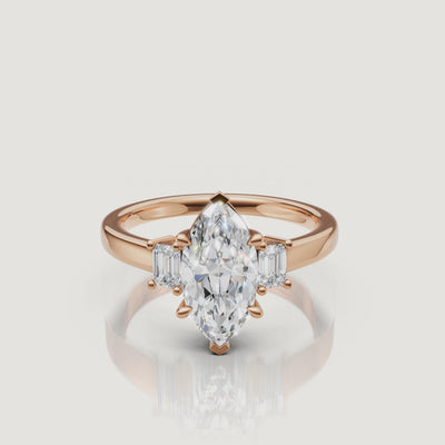 Cinematic close-up of a Rual Diamonds rose gold marquise-cut diamond ring, capturing the warm romantic tones and exceptional brilliance of the three-stone design in motion.