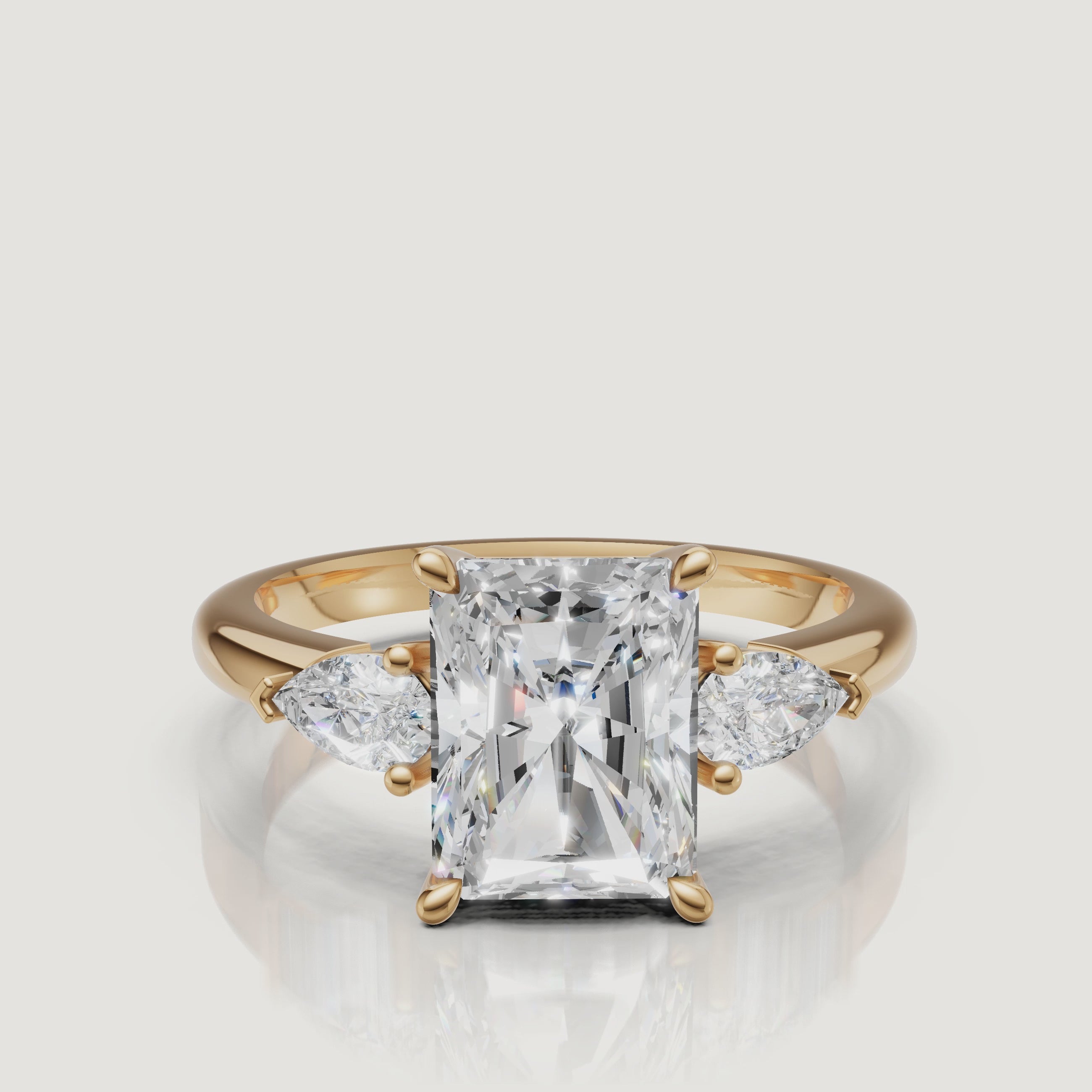 video of radiant cut lab grown diamond engagement ring with pear side stones in 14k yellow gold