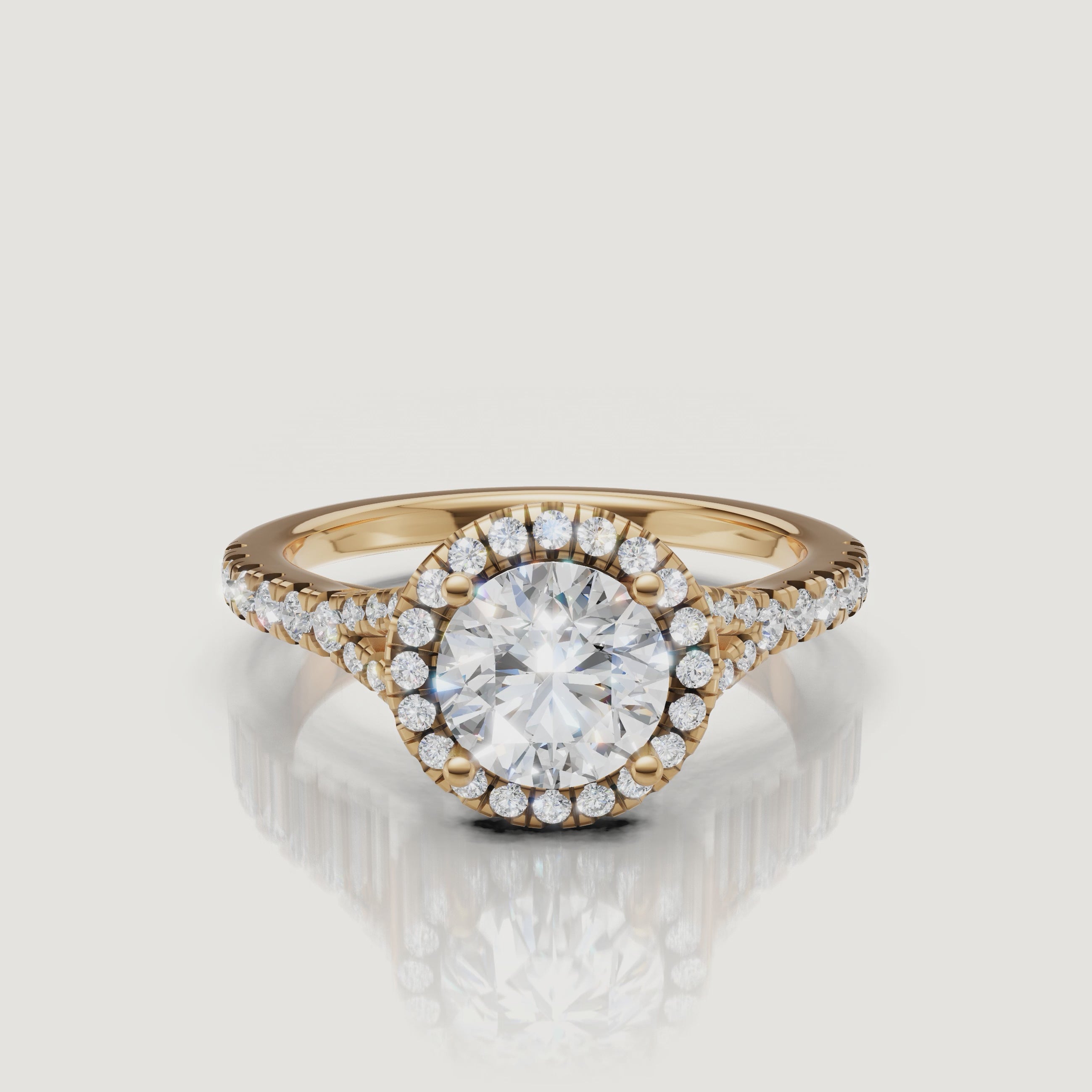 A high-definition 360-degree video of a Raul Diamonds round brilliant engagement ring in yellow gold, highlighting the fire of the center stone and the split shank detail