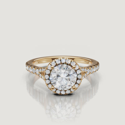 A high-definition 360-degree video of a Raul Diamonds round brilliant engagement ring in yellow gold, highlighting the fire of the center stone and the split shank detail