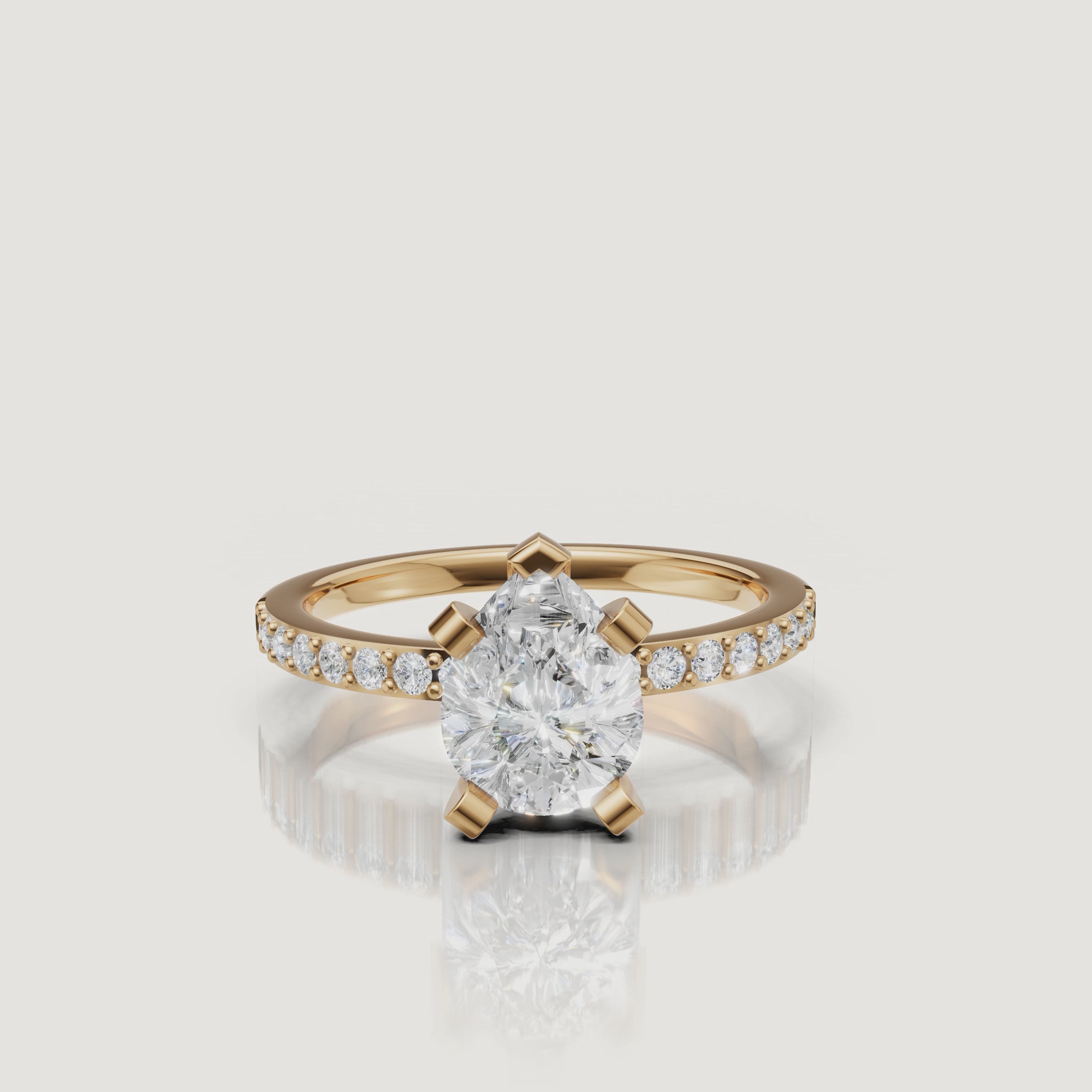 360-degree video showcase of the Raul Diamonds pear cut solitaire ring in yellow gold, highlighting the elegant teardrop shape and the shimmer of the pavé-set band.