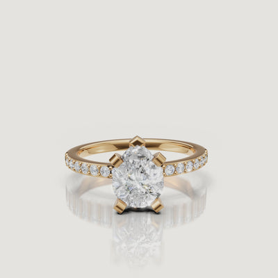 360-degree video showcase of the Raul Diamonds pear cut solitaire ring in yellow gold, highlighting the elegant teardrop shape and the shimmer of the pavé-set band.
