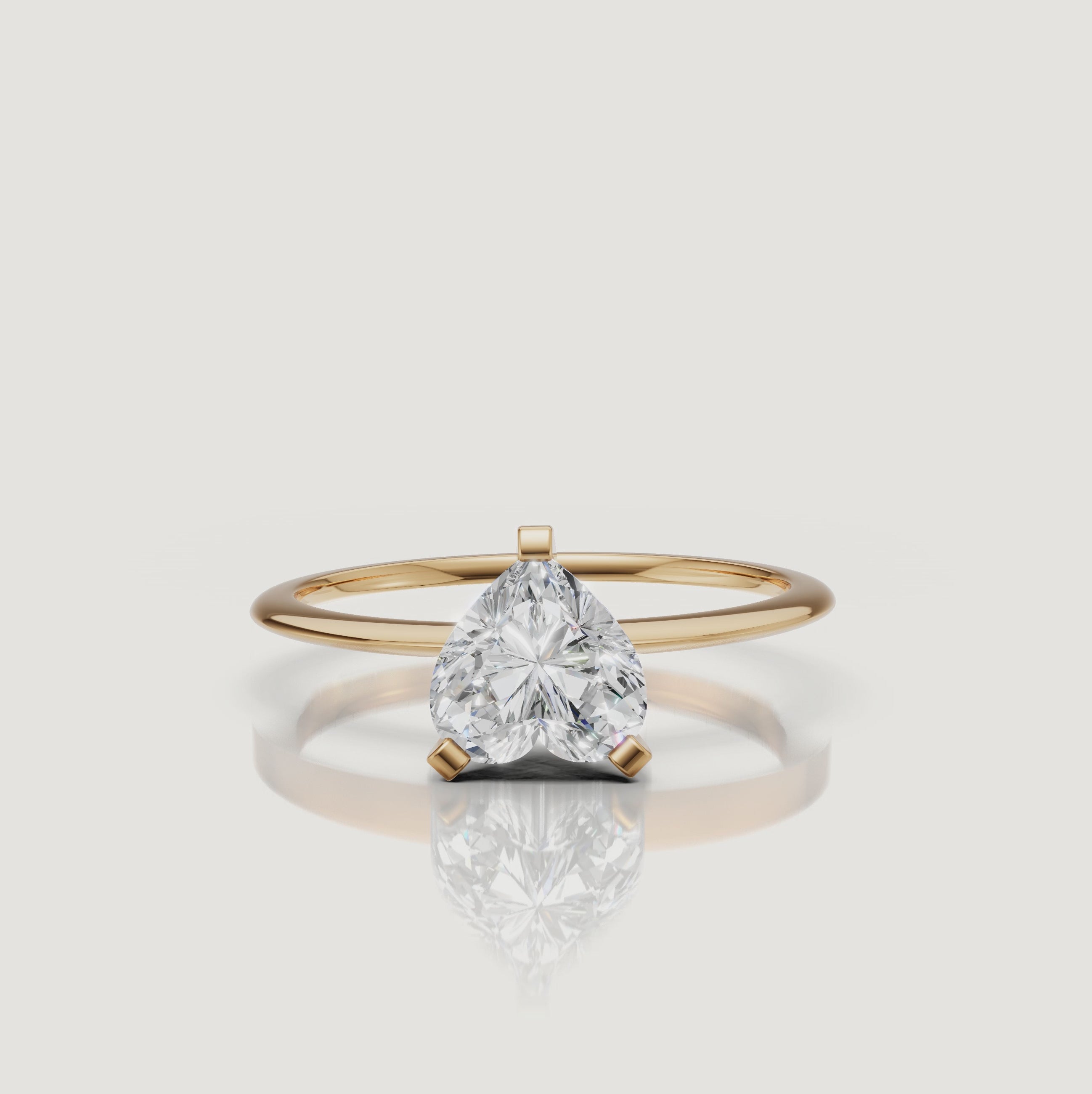 Cinematic video of a heart cut lab grown diamond solitaire engagement ring in yellow gold by Raul Diamonds featuring elegant hand movement, macro diamond sparkle, warm luxury lighting, and premium bridal jewelry styling
