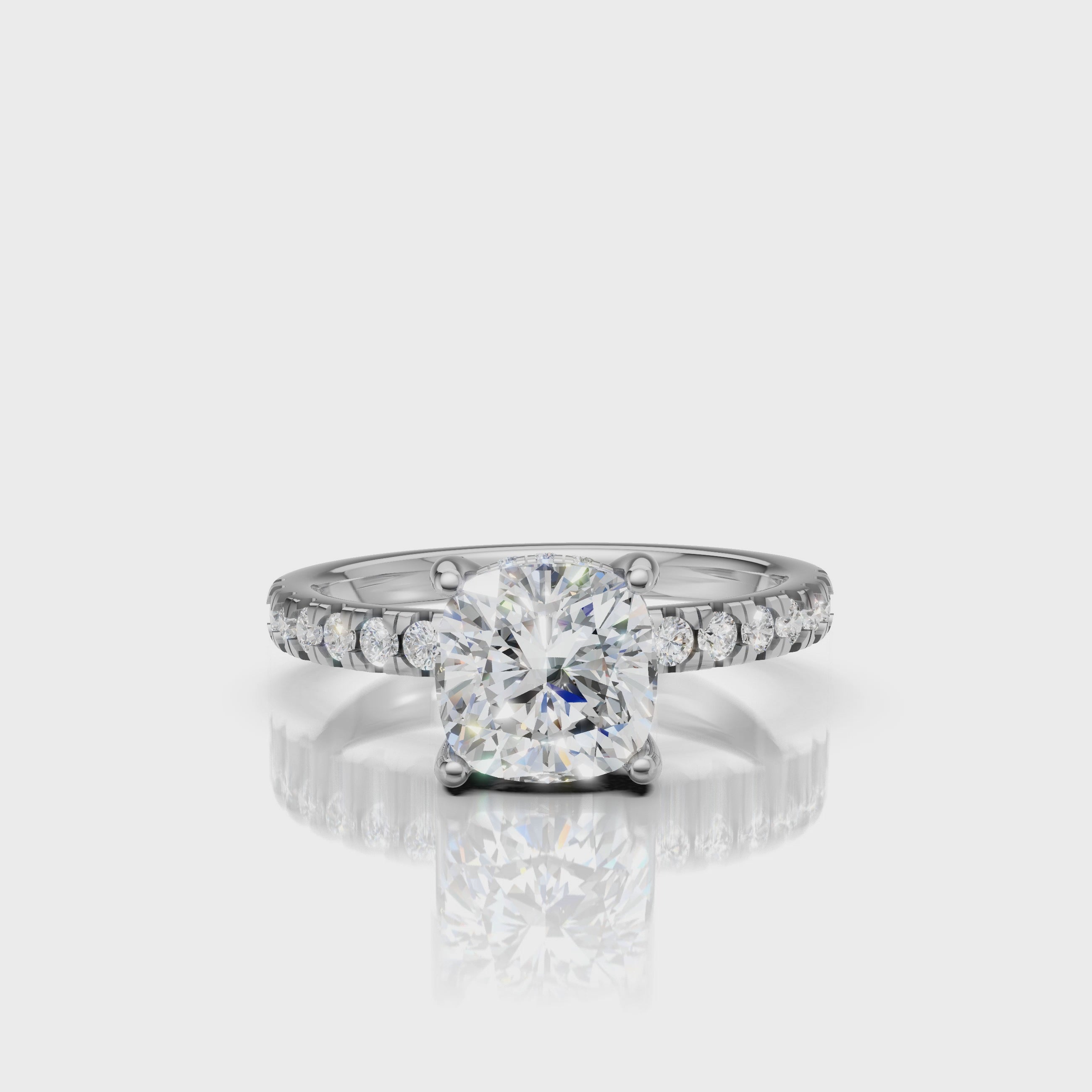 Detail-focused video of a Raul Diamonds white gold cushion-cut engagement ring, showcasing the seamless pavé setting and the colorless brilliance of the center diamond