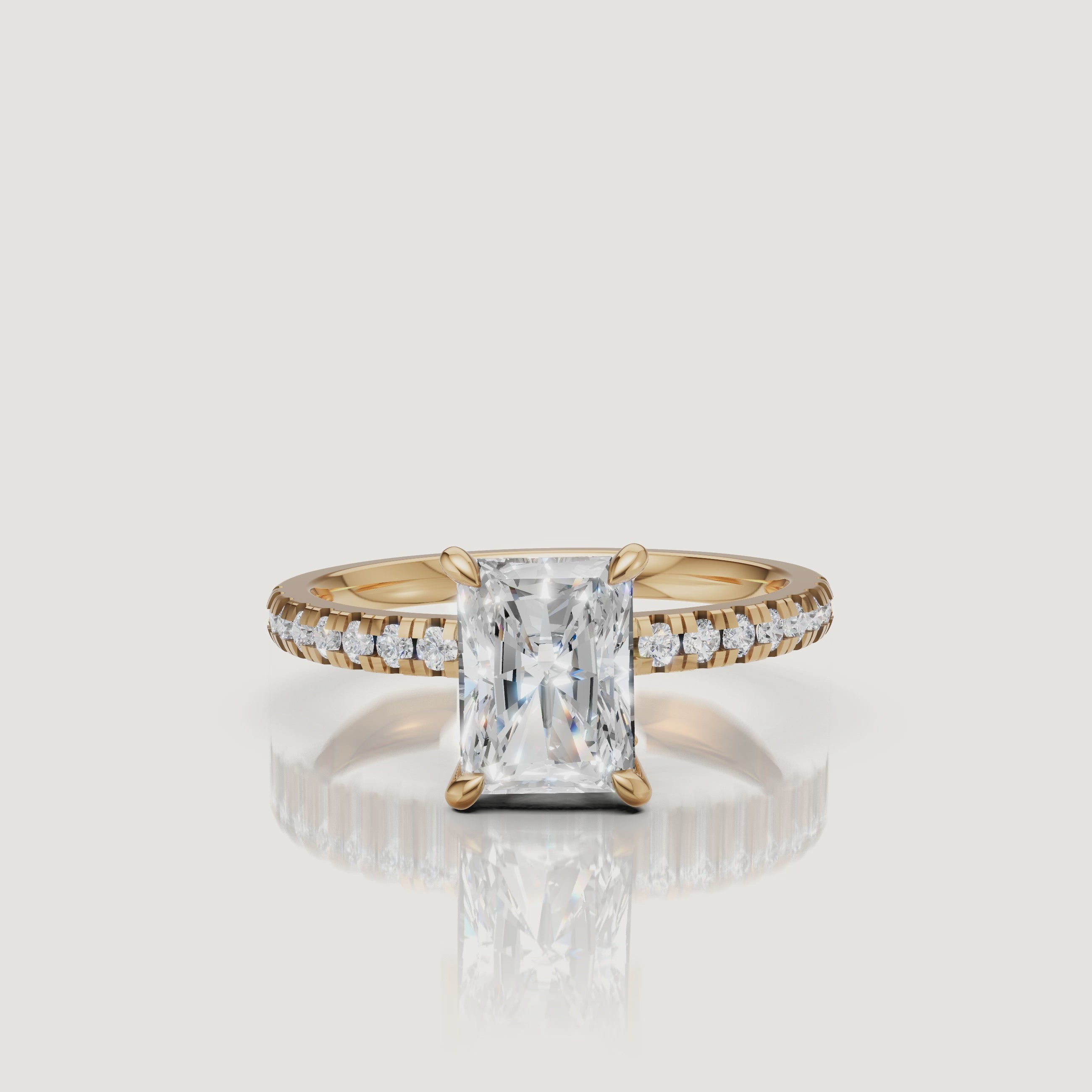 "Cinematic 360-degree video of a Raul Diamonds yellow gold radiant-cut ring, showing the brilliant light performance and the detailed hidden halo craftsmanship."