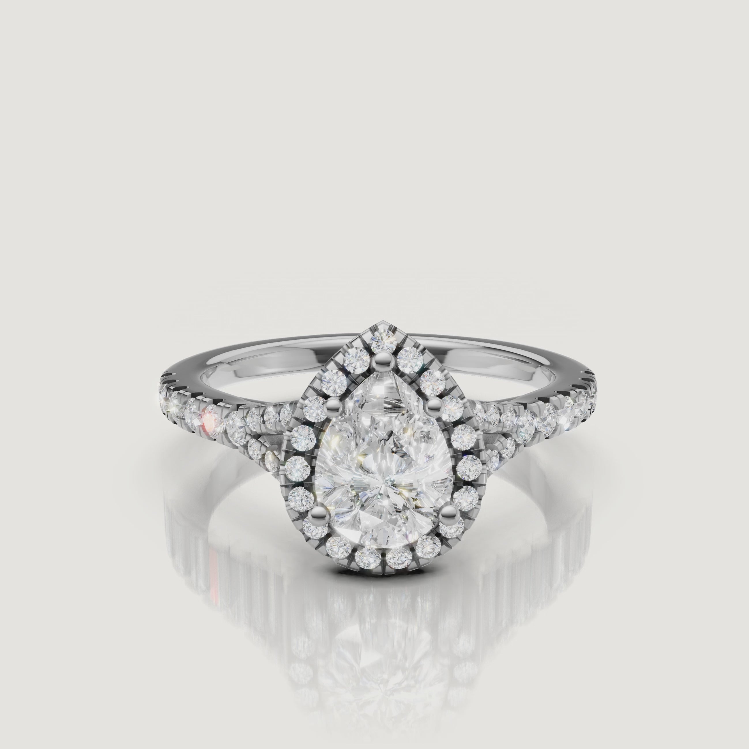 Professional video display of a white gold pear-cut diamond ring with a pavé halo, demonstrating the exceptional fire and clarity of the Raul Diamonds signature cut