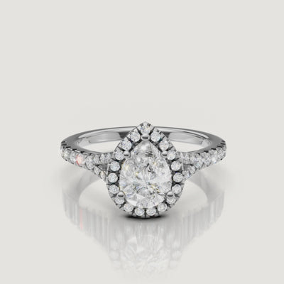 Professional video display of a white gold pear-cut diamond ring with a pavé halo, demonstrating the exceptional fire and clarity of the Raul Diamonds signature cut