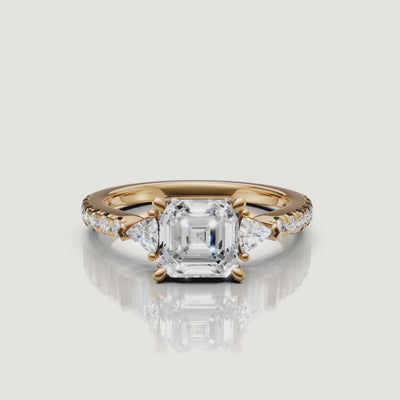 A close-up 360-degree rotation of a Rual Diamonds asscher cut engagement ring, highlighting the deep step-cut facets and brilliant trillion-cut side stones.