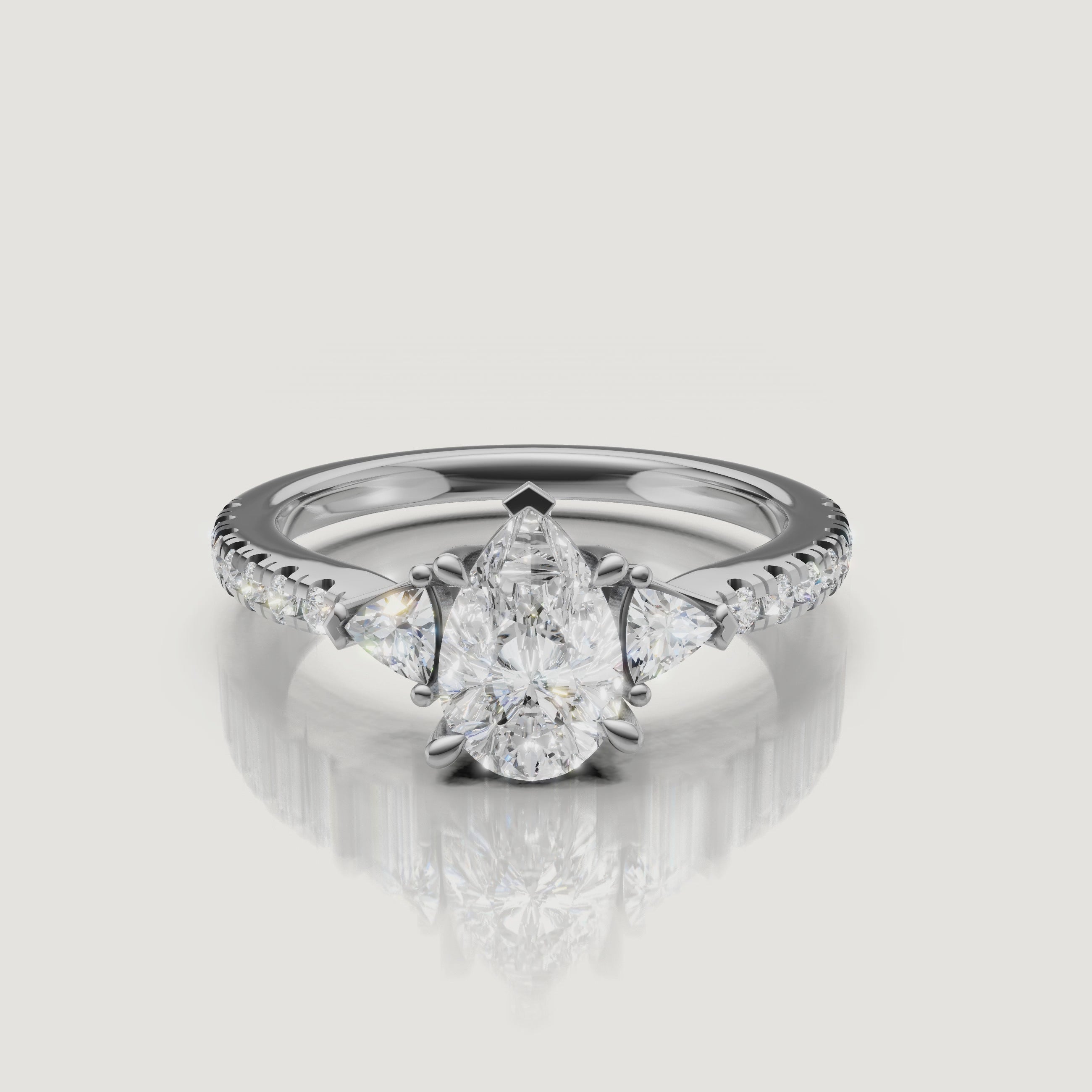 Lifestyle video of a model wearing the Rual Diamonds pear-shaped diamond ring, demonstrating the elegant elongation of the finger and the ring's movement in light