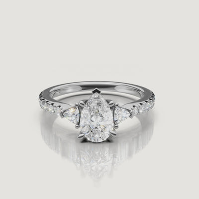 Lifestyle video of a model wearing the Rual Diamonds pear-shaped diamond ring, demonstrating the elegant elongation of the finger and the ring's movement in light