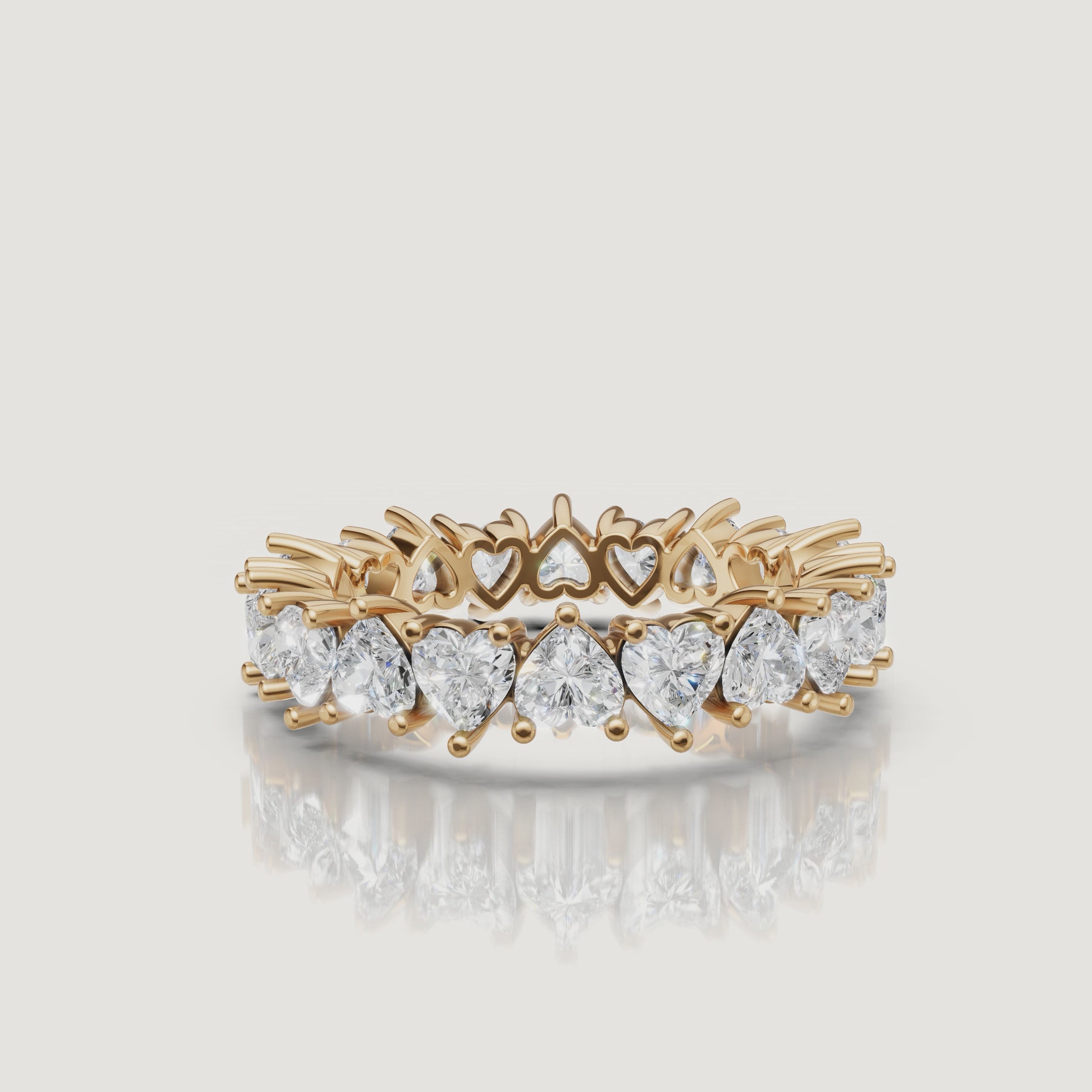 rotating view of heart shaped lab grown diamond eternity band in polished gold