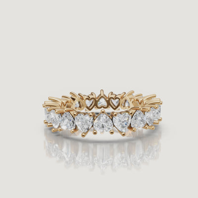 rotating view of heart shaped lab grown diamond eternity band in polished gold