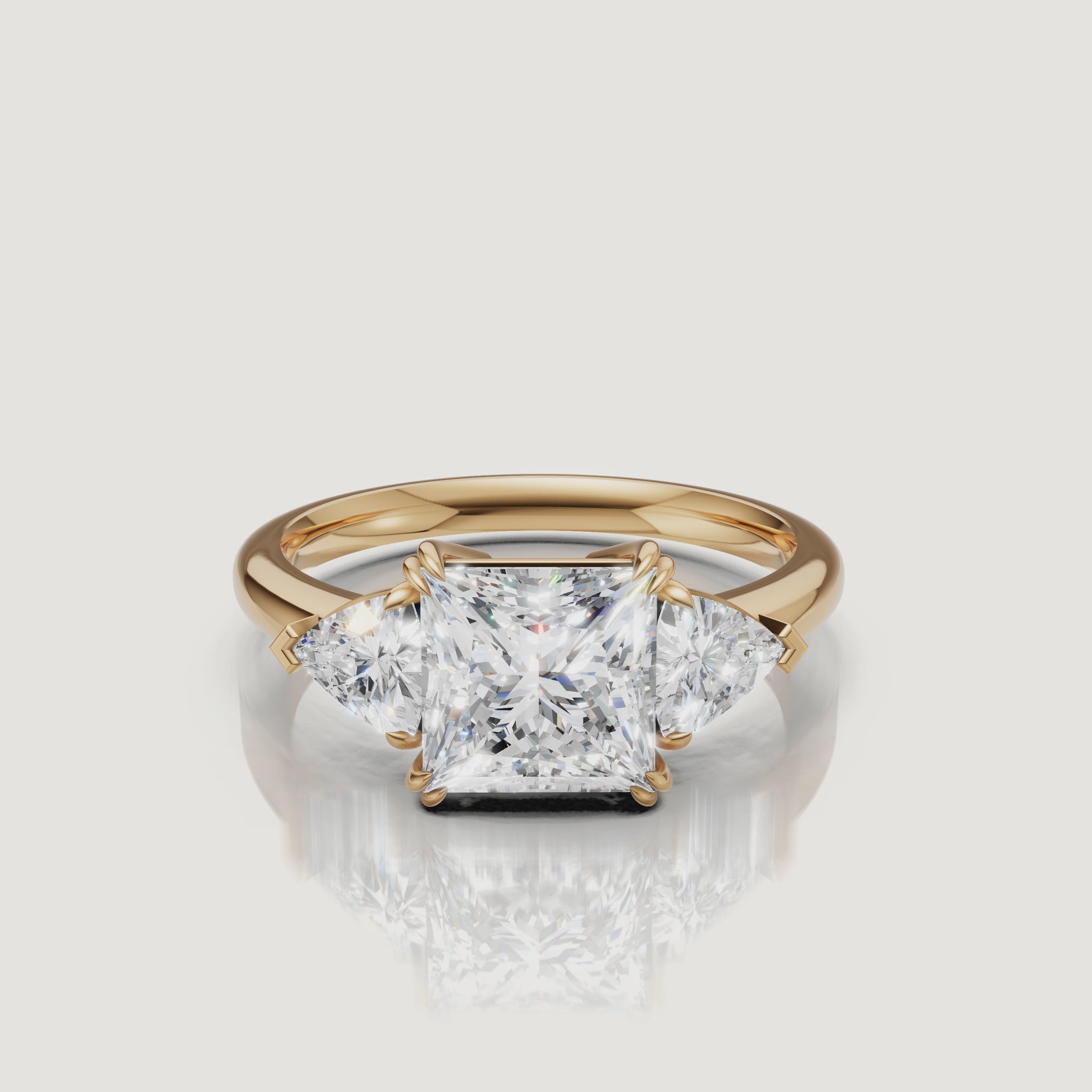 video of princess cut lab grown diamond engagement ring with trillion side stones in 14k yellow gold