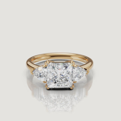 video of princess cut lab grown diamond engagement ring with trillion side stones in 14k yellow gold