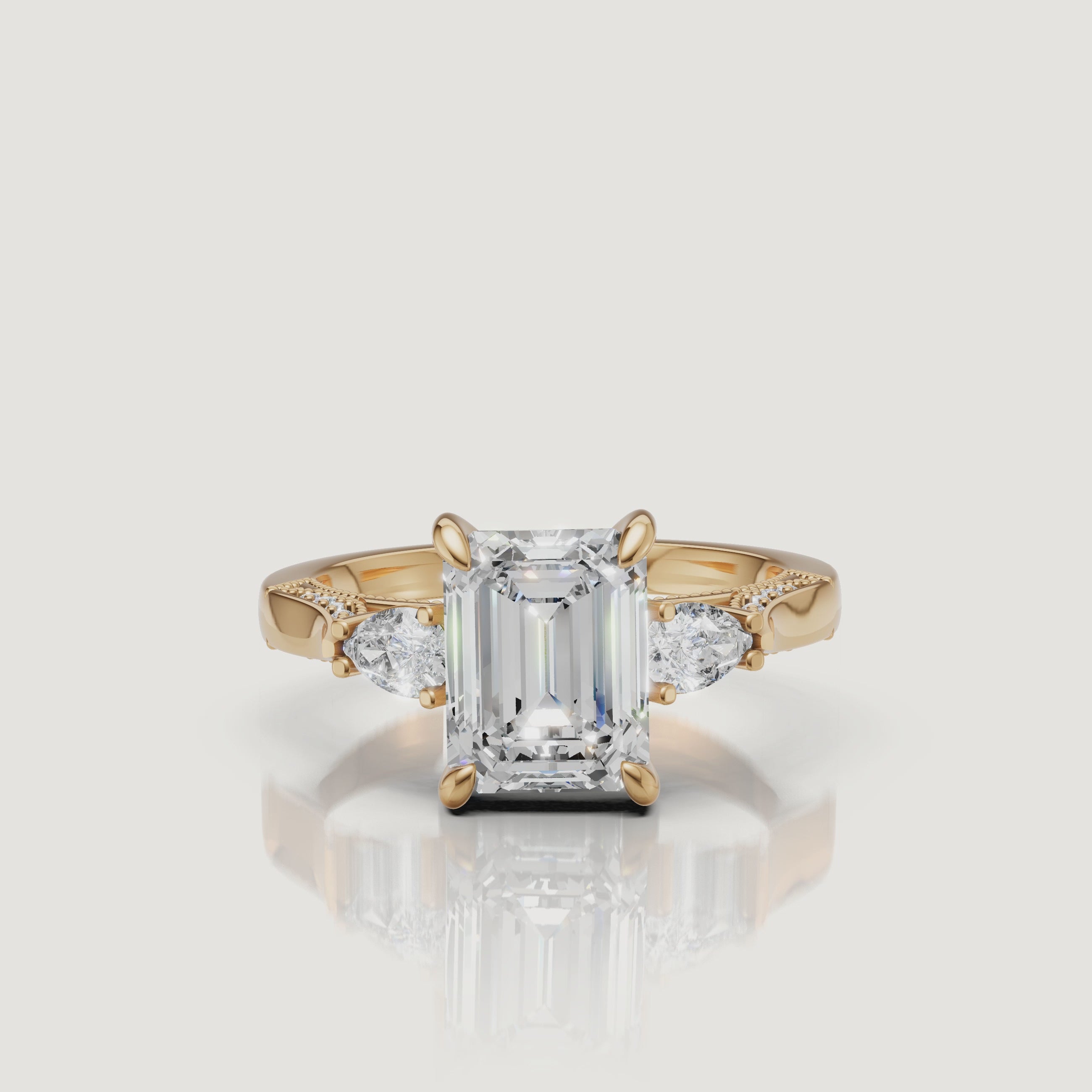Lustrous 18K Yellow Gold Emerald Cut Diamond Ring with Pear Side Stones - 360 View | Raul Diamonds