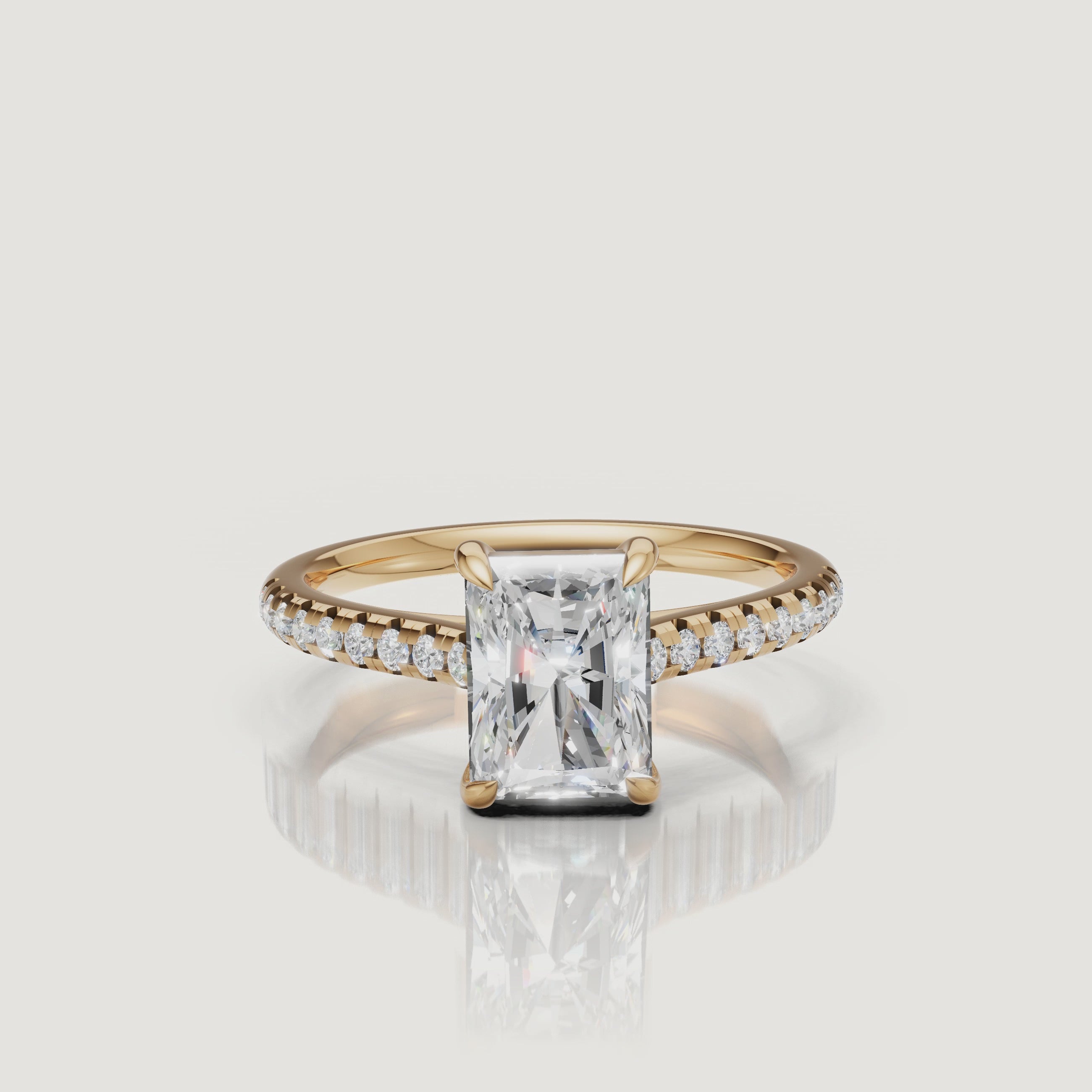 Rotating video of Raul Diamonds radiant cut yellow gold engagement ring with pavé diamond band