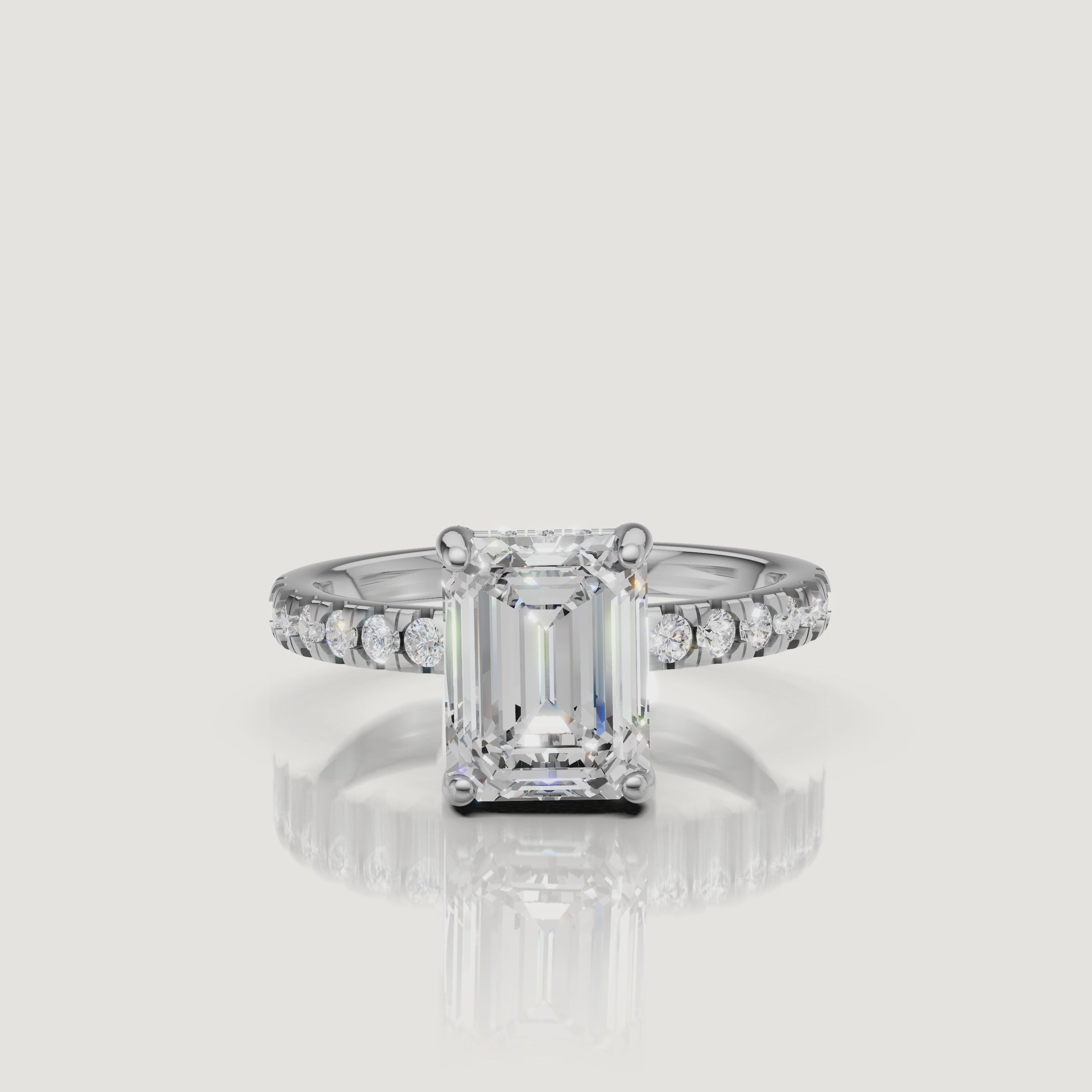 High-resolution video of a Raul Diamonds white gold emerald-cut engagement ring, showcasing the elegant hidden halo and the seamless diamond pavé band