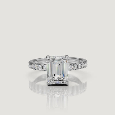 High-resolution video of a Raul Diamonds white gold emerald-cut engagement ring, showcasing the elegant hidden halo and the seamless diamond pavé band