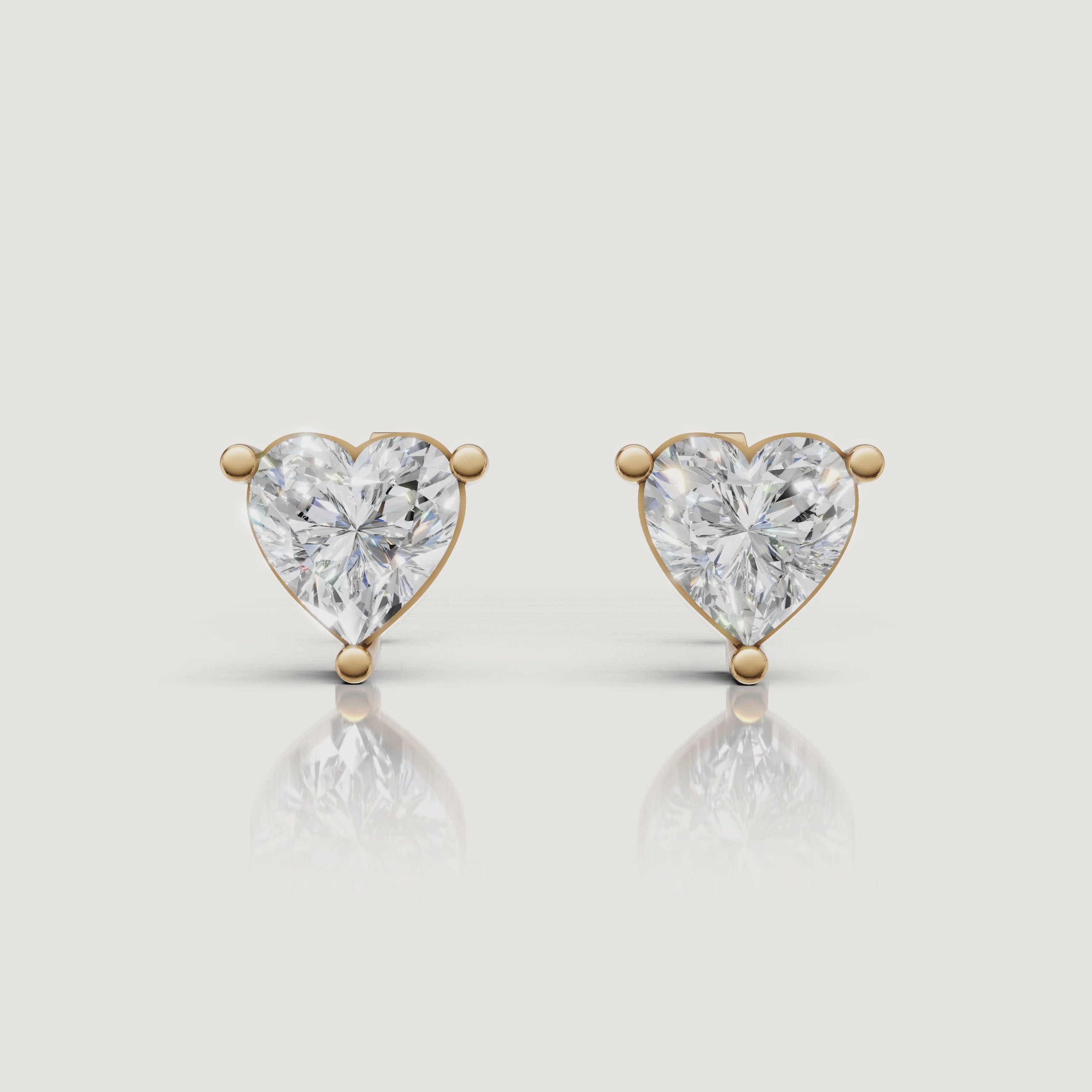 Yellow gold heart diamond stud earrings video showcasing brilliant solitaire sparkle by Raul Diamonds