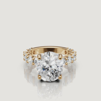 Video showcase of a Raul Diamonds oval-cut diamond engagement ring in 18k yellow gold, featuring a brilliant hidden halo and eternity band setting
