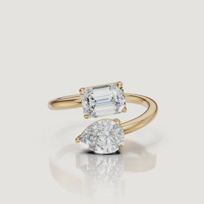Yellow Gold Video Alt: Rotating video of Raul Diamonds yellow gold bypass ring with pear and emerald cut diamonds