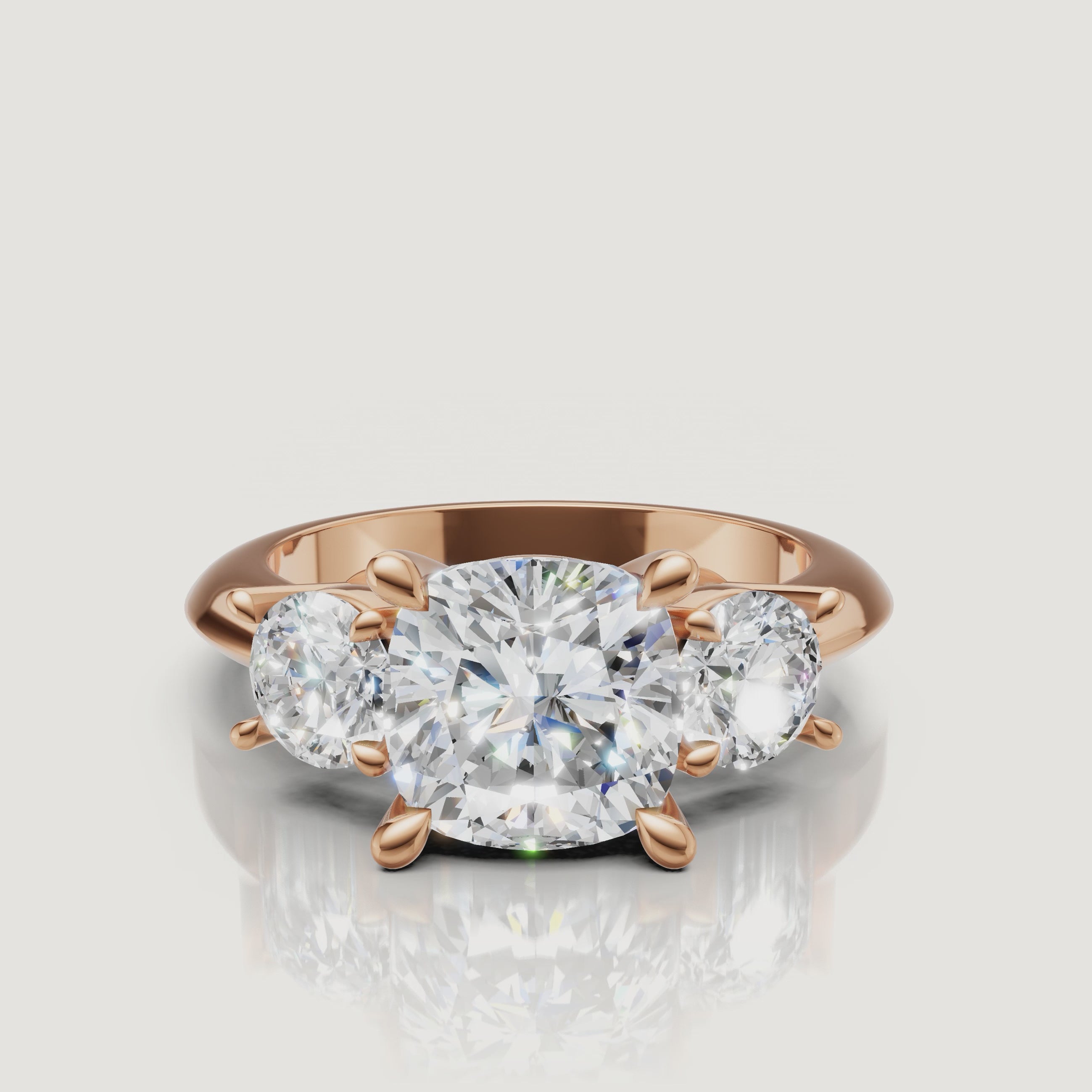 Cinematic close-up of the Sophia rose gold cushion trilogy ring, focusing on the warm blush metal and the brilliant light return of the cushion-shaped center stone.
