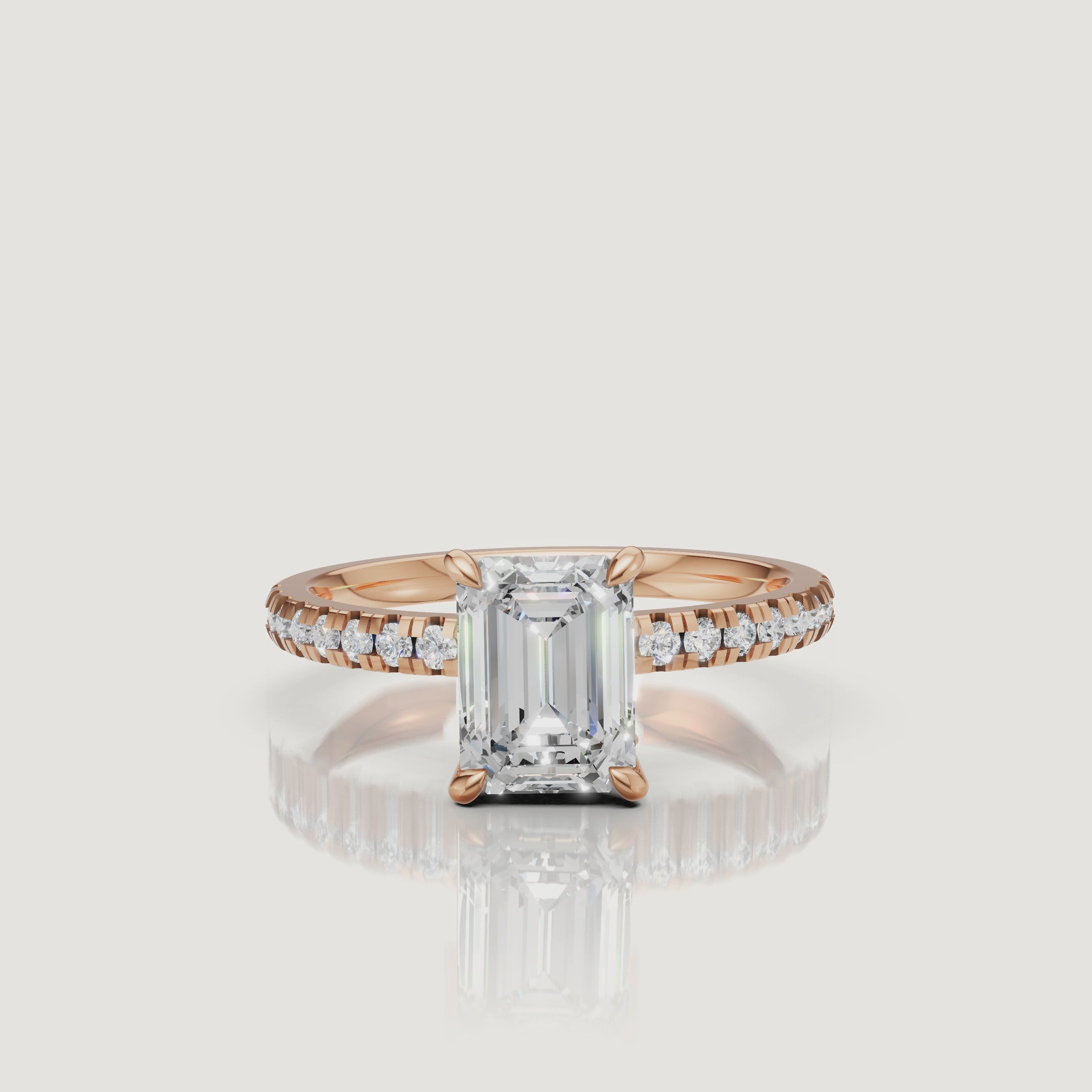 Close-up cinematic video of a romantic rose gold emerald cut diamond ring, showing the 'hall of mirrors' effect of the center stone and the brilliance of the pavé diamond accents