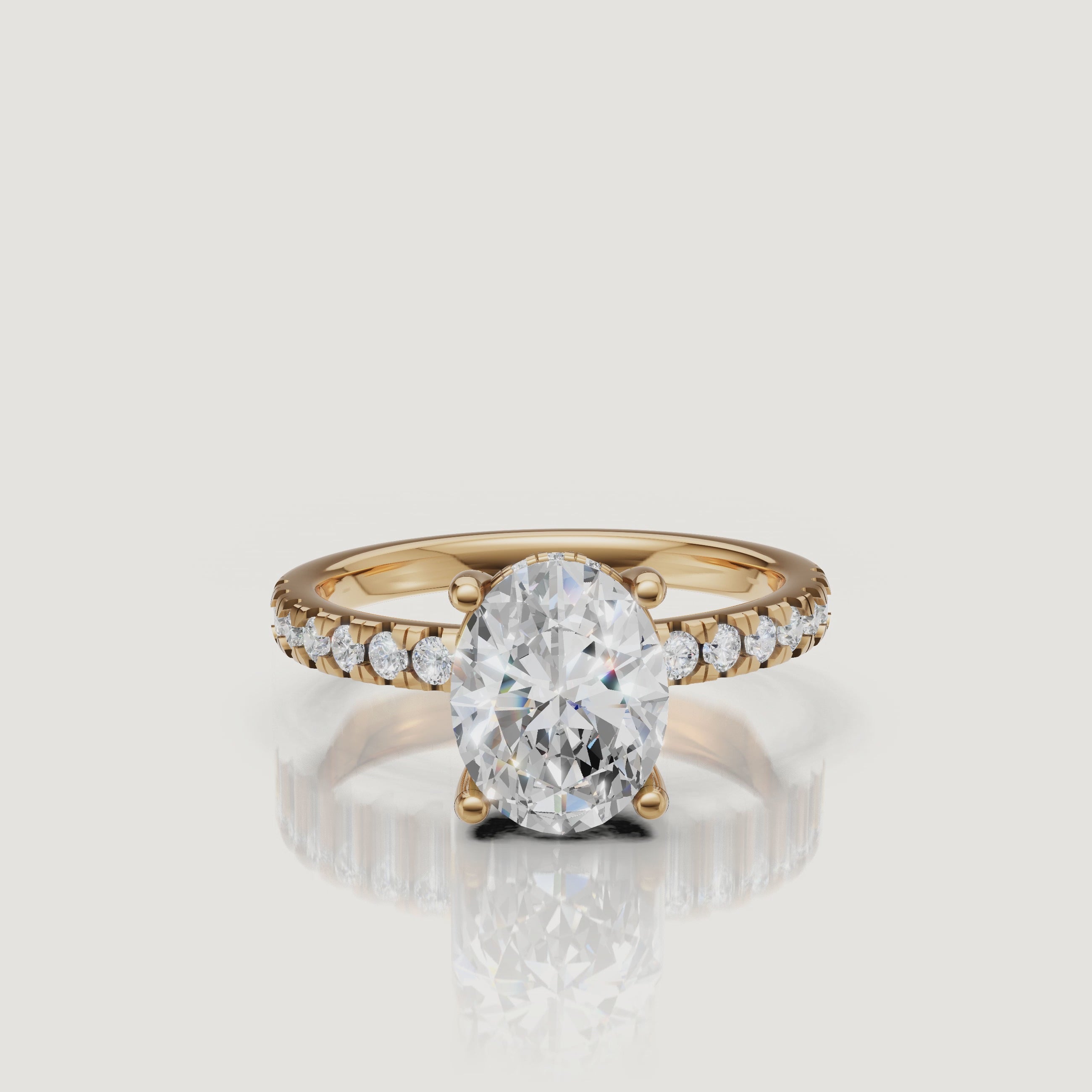 HD 360-degree video of a Raul Diamonds oval-cut engagement ring in 18k yellow gold, showcasing the hidden halo and pavé diamond band sparkle.