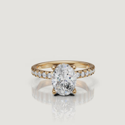 HD 360-degree video of a Raul Diamonds oval-cut engagement ring in 18k yellow gold, showcasing the hidden halo and pavé diamond band sparkle.