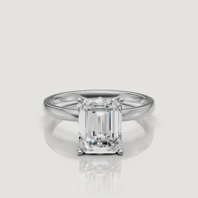 HD video showcase of a white gold emerald cut solitaire engagement ring from Raul Diamonds, demonstrating the stunning clarity and classic four-prong design