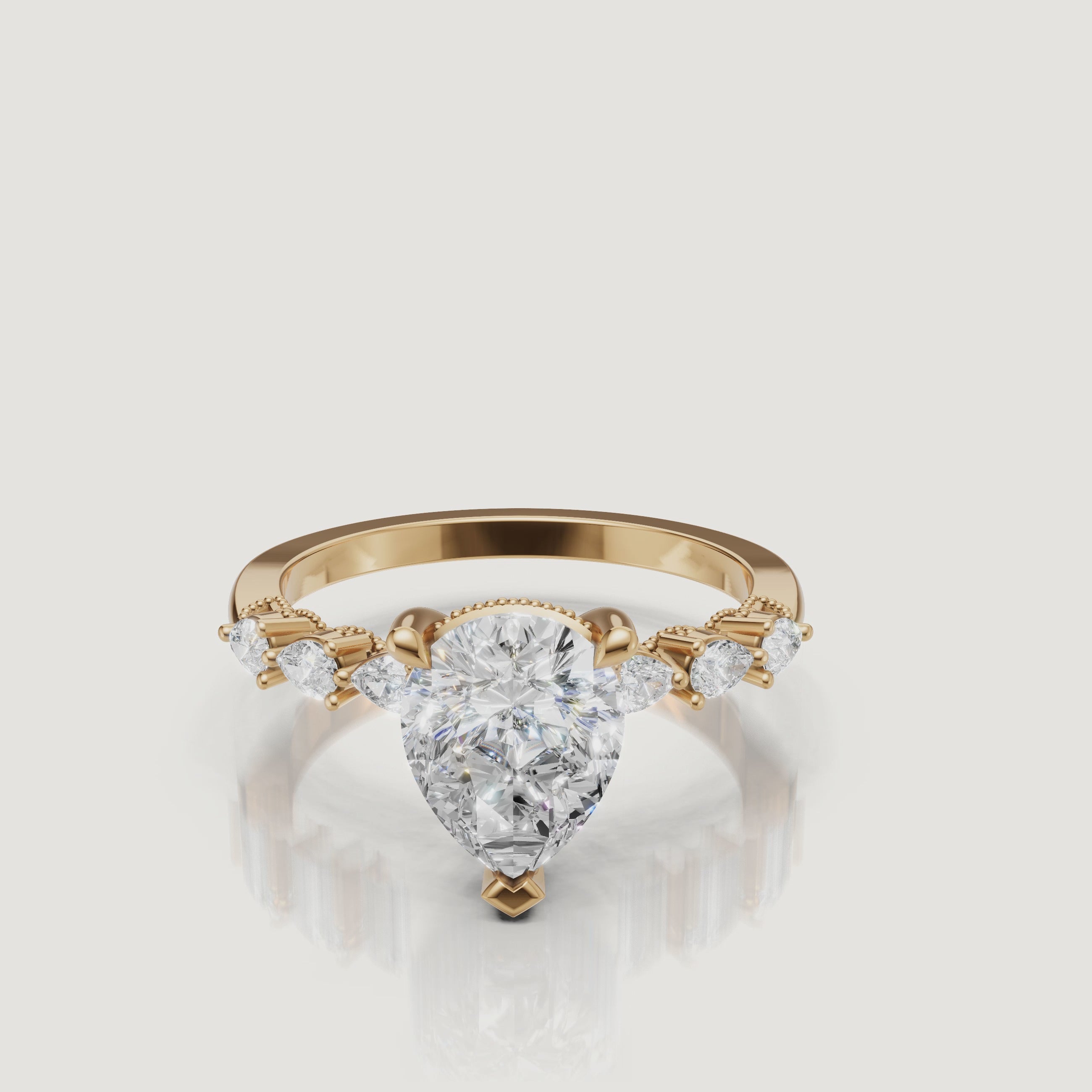 Video of pear cut lab grown diamond engagement ring in 14K yellow gold with marquise side stones by Raul Diamonds