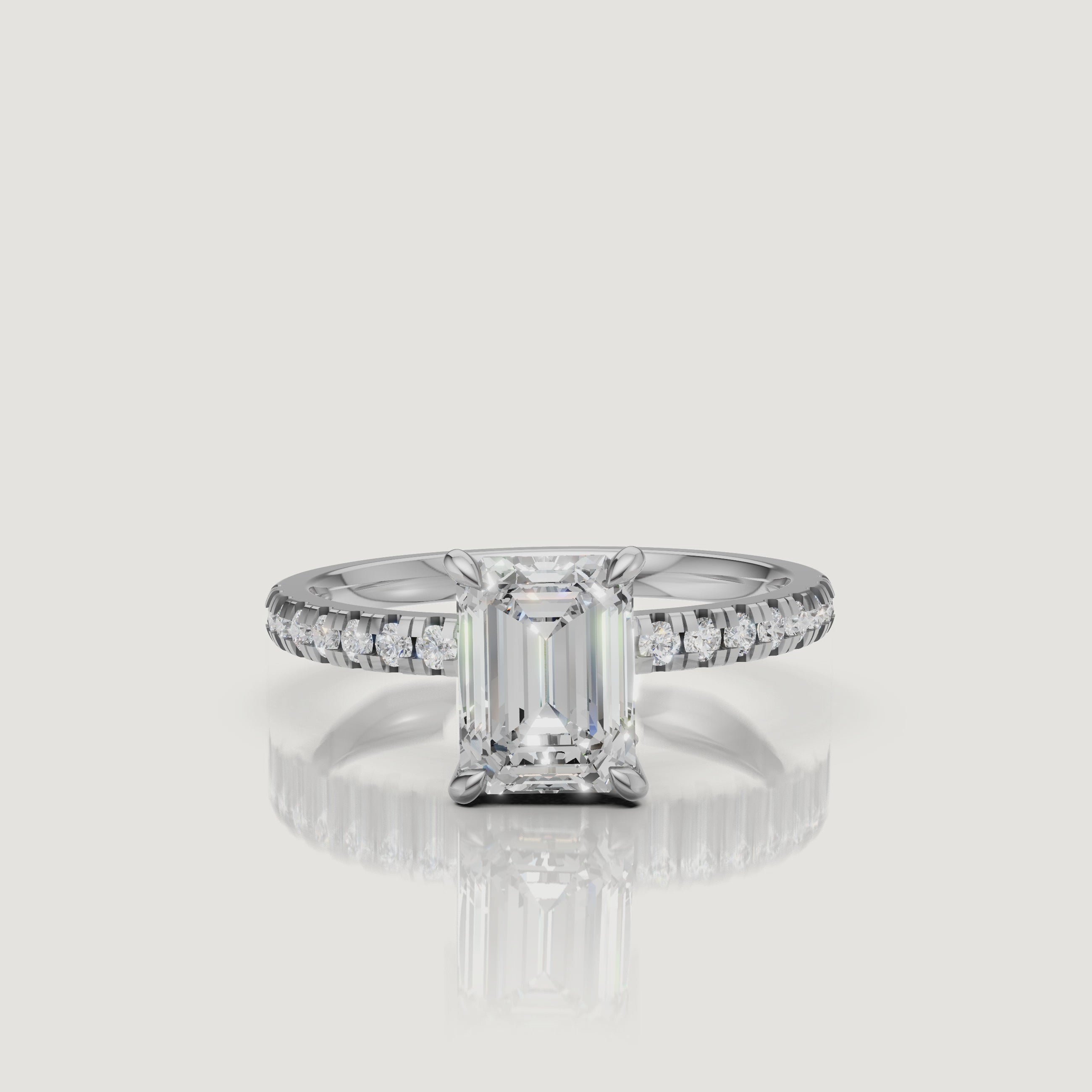 "Luxury video showcase of a Raul Diamonds white gold emerald cut engagement ring, highlighting the crisp white metal and the seamless flow of round diamonds along the band."