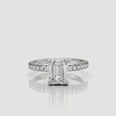"Luxury video showcase of a Raul Diamonds white gold emerald cut engagement ring, highlighting the crisp white metal and the seamless flow of round diamonds along the band."