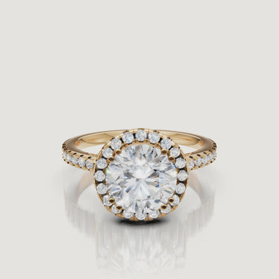 Video of round cut lab grown diamond halo engagement ring in 14K yellow gold with pavé band by Raul Diamonds