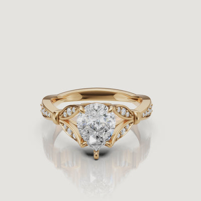 Rotating video of Raul Diamonds pear cut lab grown diamond engagement ring in 14K yellow gold with pavé accents
