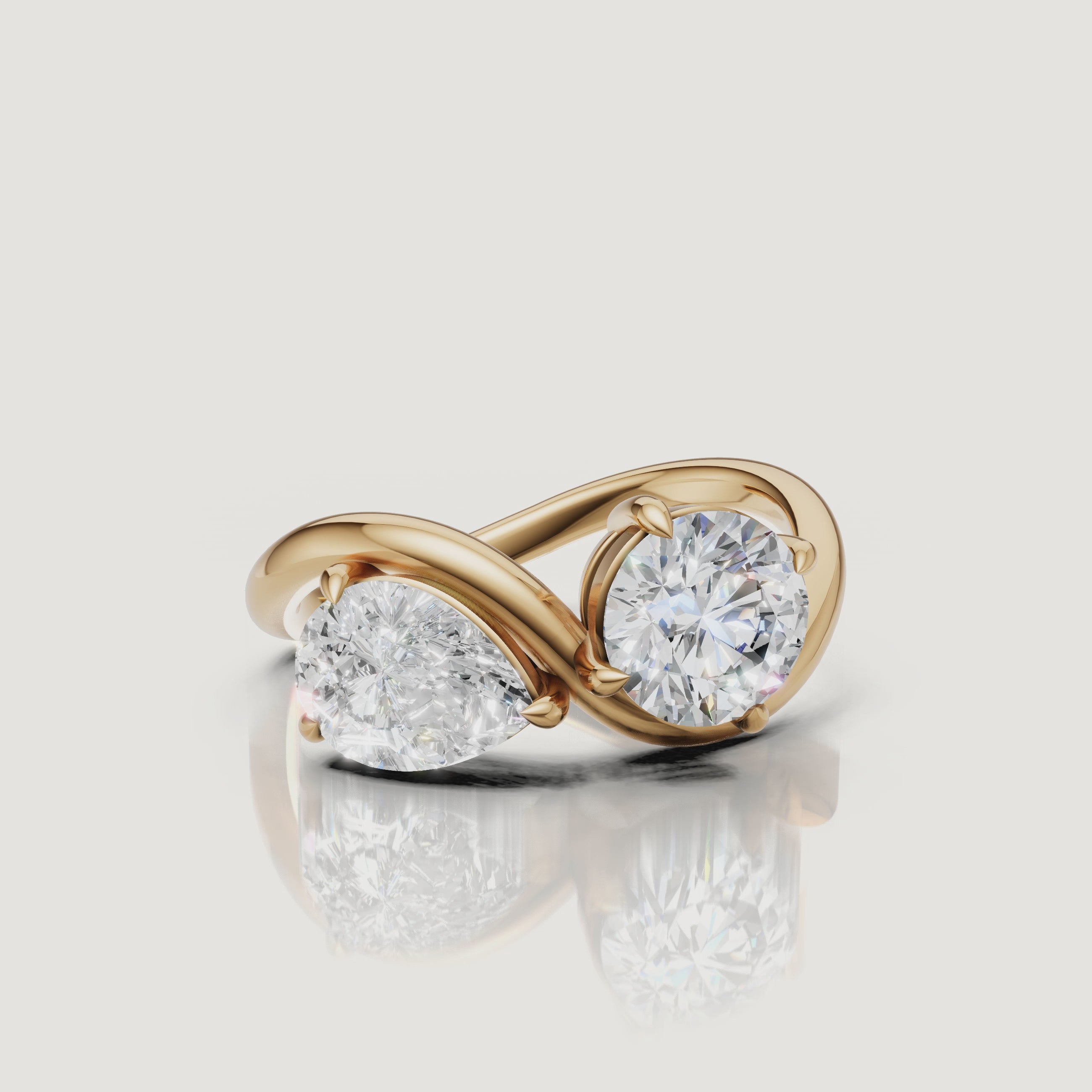 Yellow gold toi et moi diamond ring video featuring pear and round brilliant diamonds by Raul Diamonds