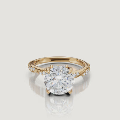 14K yellow gold round cut lab grown diamond engagement ring with twisted pavé band and brilliant sparkle by Raul Diamonds
