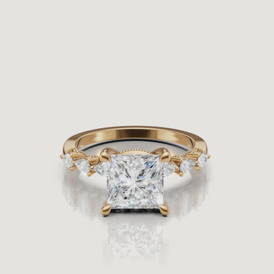 Video of princess cut lab grown diamond engagement ring in 14K yellow gold with marquise side stones by Raul Diamonds