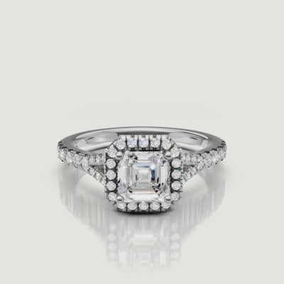 High-definition video of a white gold Asscher cut diamond ring with a pavé halo and split shank, showcasing the clarity and fire of the center stone