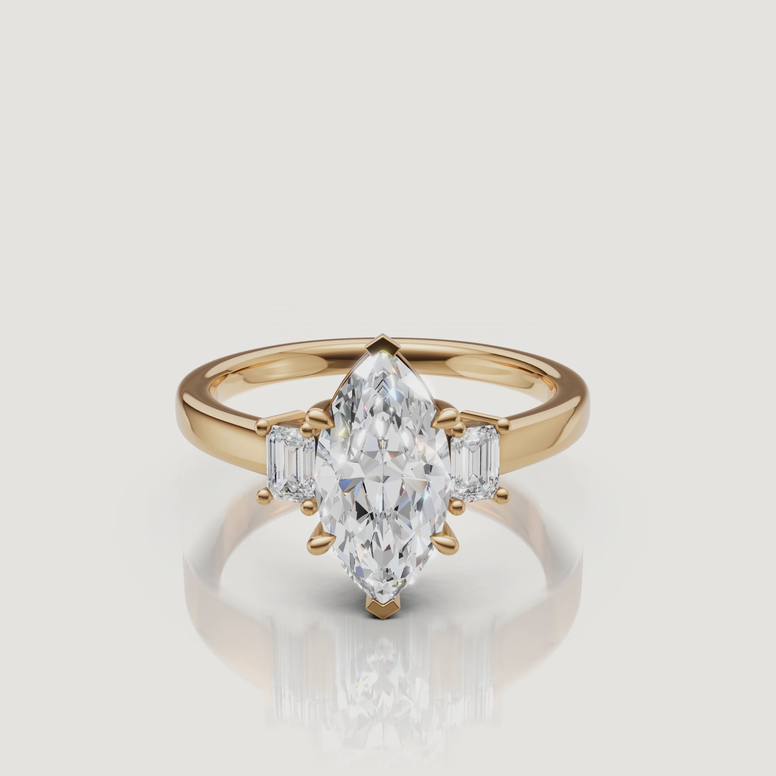 A high-definition 360-degree rotation of a Rual Diamonds marquise-cut three-stone ring in 14k yellow gold, showcasing the elegant teardrop-like points and shimmering pavé shank