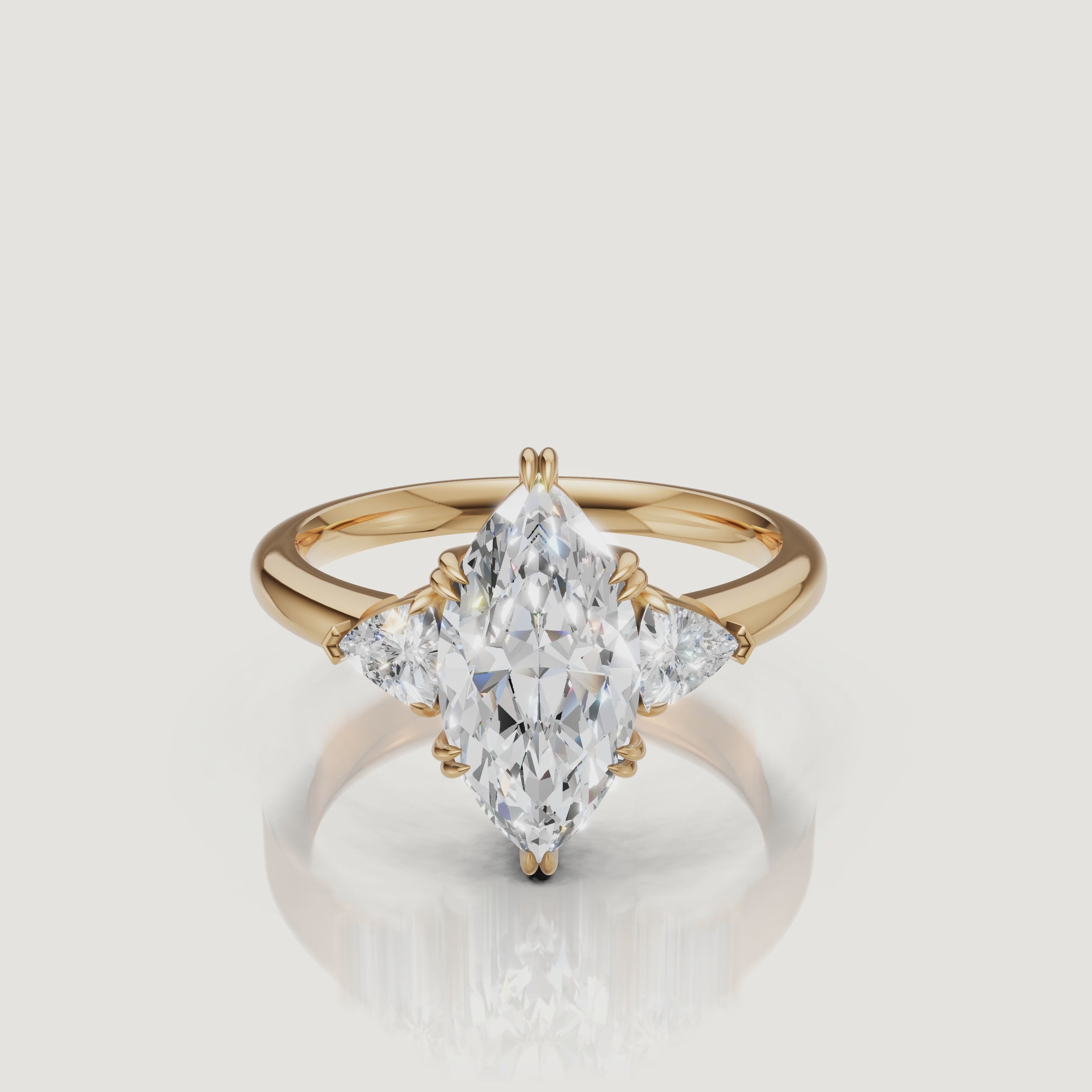 video of marquise cut lab grown diamond engagement ring with trillion side stones in 14k yellow gold